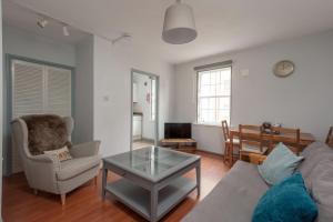a living room with a couch and a table at The Wee Highland Coo in Edinburgh