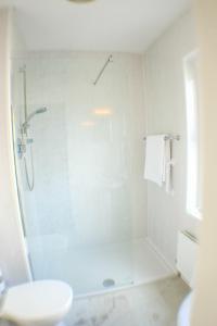 a white bathroom with a shower and a sink at The Yewdale Inn and Hotel Coniston Village in Coniston +55 photos