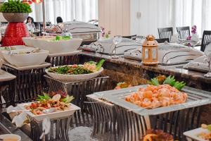 a buffet line with many plates of food at Sapphire Plaza Hotel in Doha