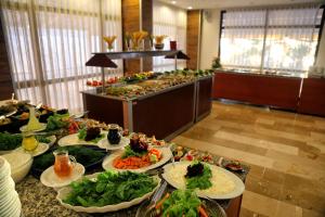 a buffet with many plates of food on a table at Çeşme Farm Hotel in Çeşme
