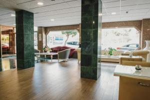 a lobby with green pillars in a building at Hotel Embajador in Almería