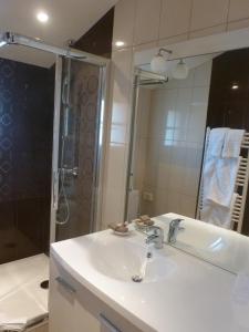 a bathroom with a white sink and a shower at Hotel Bel Air in Saint-Jean-de-Luz