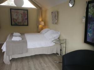 een slaapkamer met een wit bed en een tafel bij Maizon Middelburg in Middelburg
