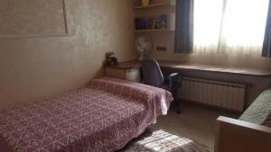 a bedroom with a bed and a desk and a window at Villa SportLife in Lloret de Mar +36 photos