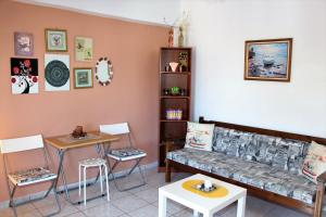 a living room with a couch and a table and chairs at Apokoros Craft Deco Apartments&Studios in Kalyves