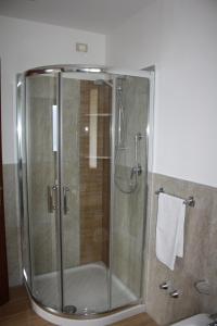 a shower with a glass door in a bathroom at Ca Vecia in Gargnano