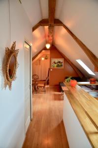 an attic room with a wooden floor and a staircase at Le gite d'Or in Vouvray