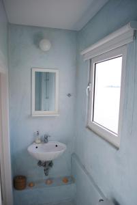 a bathroom with a sink and a window at Villa "Pietra e Mare" in Nafpaktos