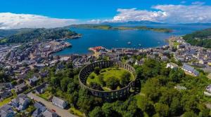 an aerial view of a city and a lake at Argyll Mansions Penthouse in Oban +12 photos