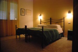 a bed in a bedroom with two lights on the wall at Sorecanu in Pula