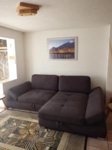 a living room with a couch and a painting on the wall at Haus Thomas in Telfs