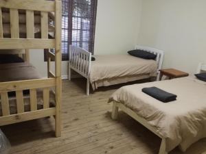 a room with two bunk beds and a room with two at Paarl Backpackers in Paarl