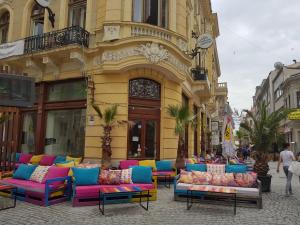 a group of colorful couches sitting outside of a building at Bucharest Pedestrian Old Town 3 Bedrooms by Orchid Garden in Bucharest