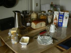 a counter top with bread and other ingredients on it at Aakirkeby Bed and Breakfast in Åkirkeby