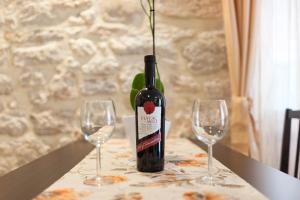 a bottle of wine sitting on a table with two glasses at Apartments Palace Rialto in Šibenik +15 photos