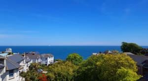 a house on a hill overlooking the ocean at Medehamstede Hotel in Shanklin