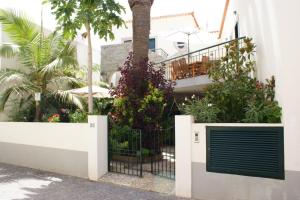 un cancello di fronte a un edificio con piante di Villa Pitta a Vila Baleira