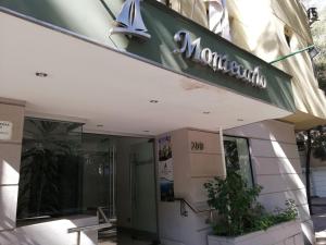 a building with a sign on the front of it at Hotel Montecarlo Santiago in Santiago