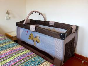 a diaper bag is sitting on a bed at Gemütliches Apartment in Strandnähe in Dranske