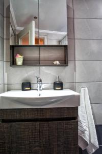 a bathroom with a sink and a mirror at The Old Salt in Kavala