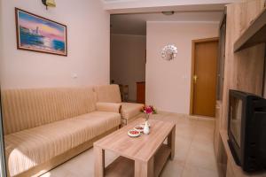 a living room with a couch and a table at Villa Del Mar in Sutomore