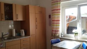 a kitchen with a sink and a table and a window at Wendler`s Haus in Meuselwitz