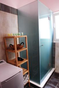 a shower with a glass door in a bathroom at Marlera Corfu Old Town Apt in Corfu Town