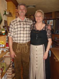 a man and a woman standing in a kitchen at gasthof lederhose in Diepenbeek