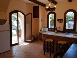 a kitchen with a counter and two arched windows at La Limonaia in Castel Volturno