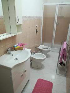 a bathroom with a sink and a toilet and a shower at Lolita Studios in Marsala