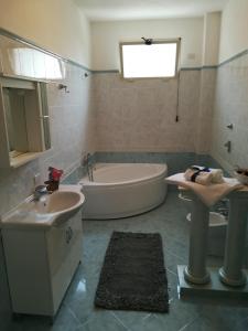 a bathroom with a tub and a sink and a bath tub at Lolita Studios in Marsala
