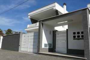 a modern house with white garage doors at Sosta Rock in Casal Palocco