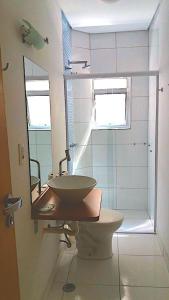 a bathroom with a sink and a toilet and a shower at Hotel Luxatel (Adults Only) in Sao Paulo