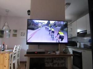 a television screen with a group of cyclists on a road at Cap del Tarter Apartament in El Tarter