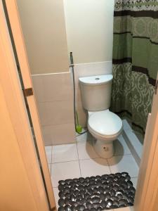 a small bathroom with a toilet and a shower at Centropolis in Manila