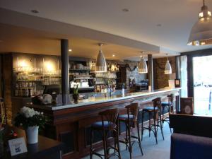 a bar in a restaurant with bar stools at Le Cadoudal in Auray