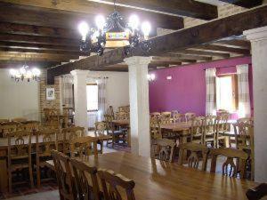 a dining room with tables and chairs and purple walls at Pago de Trascasas in Cubillas de Santa Marta