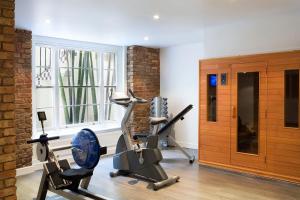 a gym with two exercise bikes in a room at The Caesar Hotel in London