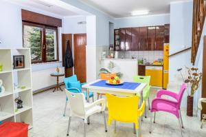 a kitchen with a table and colorful chairs at Hostel White Town in Belgrade