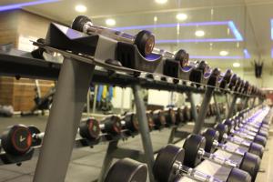a row of dumbbells in a gym at Home Suites Boutique Hotel in Freetown
