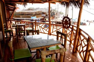 a restaurant with a table and chairs on a balcony at La Pachamama in Máncora