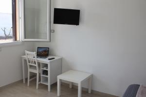 a room with a desk with a laptop and a chair at Piccolo Ulivo B&B Salento in Vernole