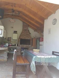 a room with a table and a kitchen with a clock at Vila Teodora in Star Dojran