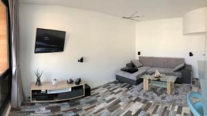 a living room with a couch and a table at MARINA 177 DEAUVILLE in Deauville