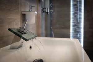 a bath tub with a soap dispenser on top of it at APARTAMENT ELEGANCE PINK in Rewal +28 photos