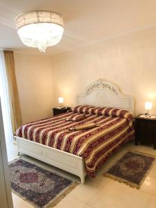 a bedroom with a bed and two night stands at Atticus Apartment in Giardini Naxos