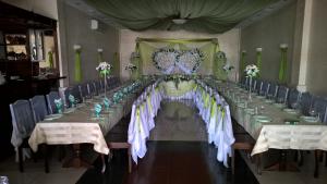 a long table set up for a wedding with flowers at Dnister Hotel Complex in Zhvanets