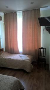 a bedroom with two beds and a window at Dnister Hotel Complex in Zhvanets
