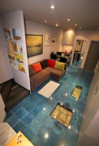 a living room with a couch and tile floor at Studio apartment ART in Split