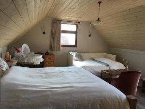 Postel nebo postele na pokoji v ubytování B&B De Hostelier